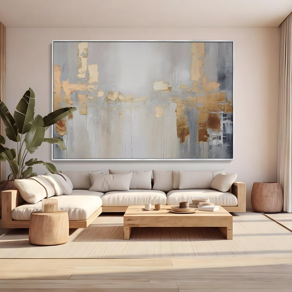 Tablou canvas cu pictura abstracta cu pete aurii si gri, in rama de aluminiu argintiu, pe perete intr-un living